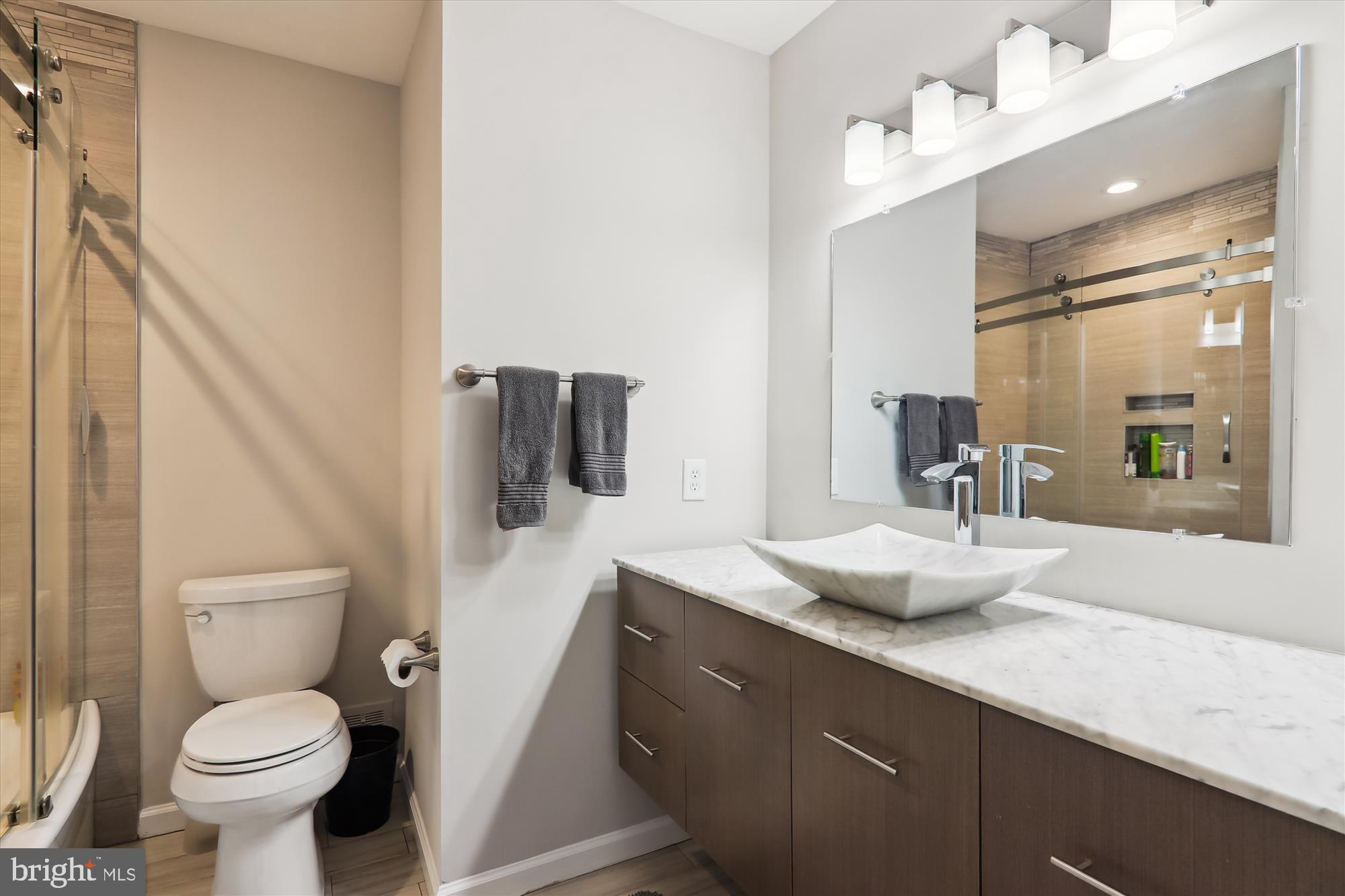 11804 Lovejoy Street Silver Spring, MD 20902 - Photo 23 of 45 a bathroom with a granite countertop sink toilet and mirror
