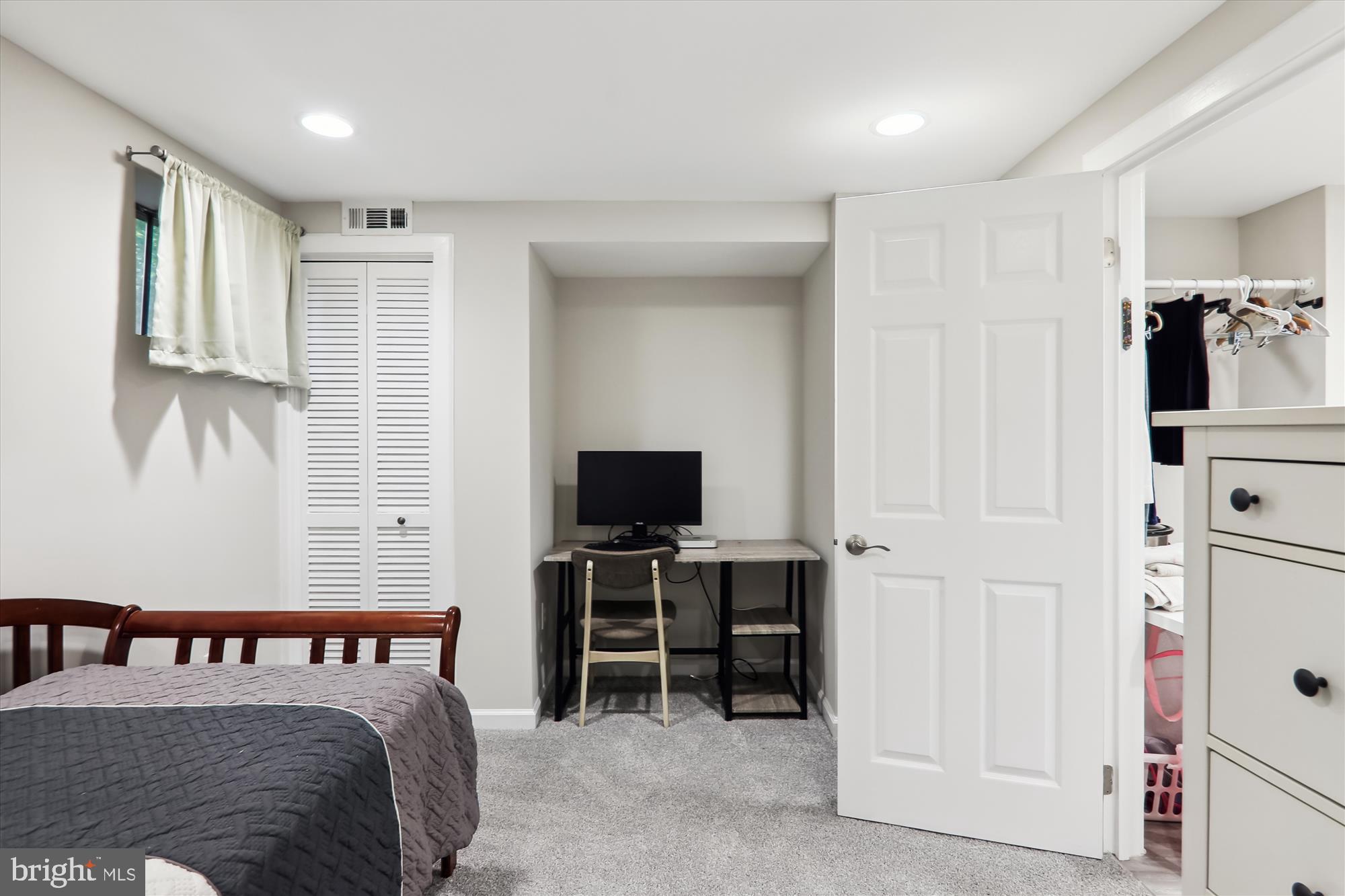 11804 Lovejoy Street Silver Spring, MD 20902 - Photo 32 of 45 a bedroom with furniture and a flat tv screen