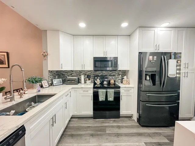 a kitchen with a sink stainless steel appliances and cabinets