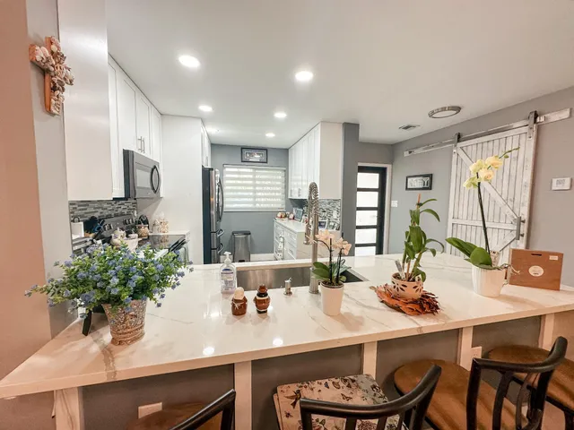 a kitchen with a table and chairs in it