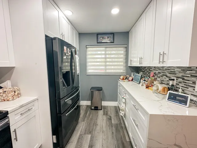 a kitchen with a refrigerator stove and sink
