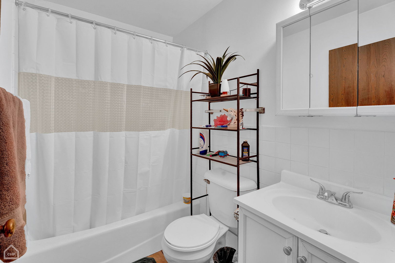 645 South Virginia Road, Unit 123 Crystal Lake, IL 60014 - Photo 14 of 17 a white toilet sitting next to a bathroom sink