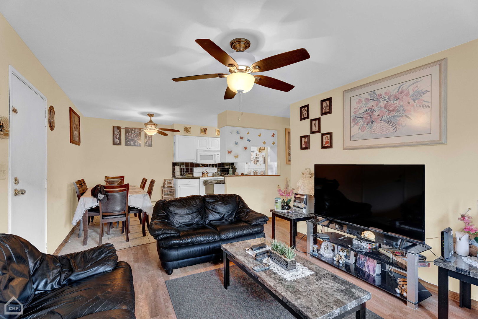645 South Virginia Road, Unit 123 Crystal Lake, IL 60014 - Photo 2 of 17 a living room with furniture and a flat screen tv