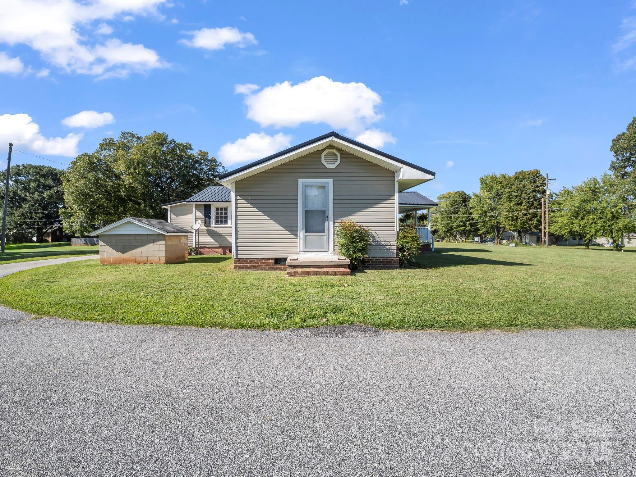 264 Goode Road Mooresboro, NC 28114 - Photo 30 of 36 a house with green field in front of it