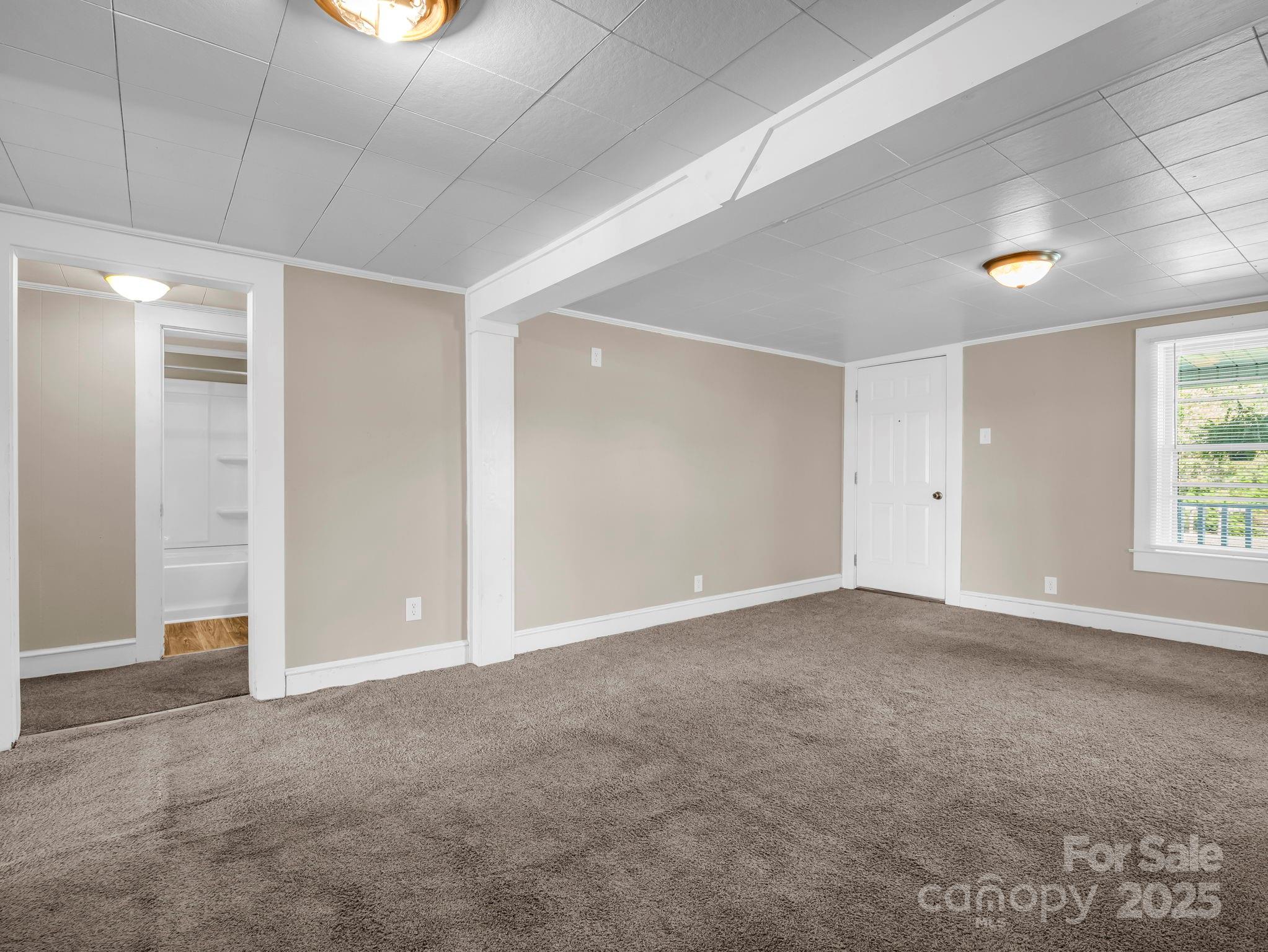 264 Goode Road Mooresboro, NC 28114 - Photo 6 of 36 an empty room with windows and closet