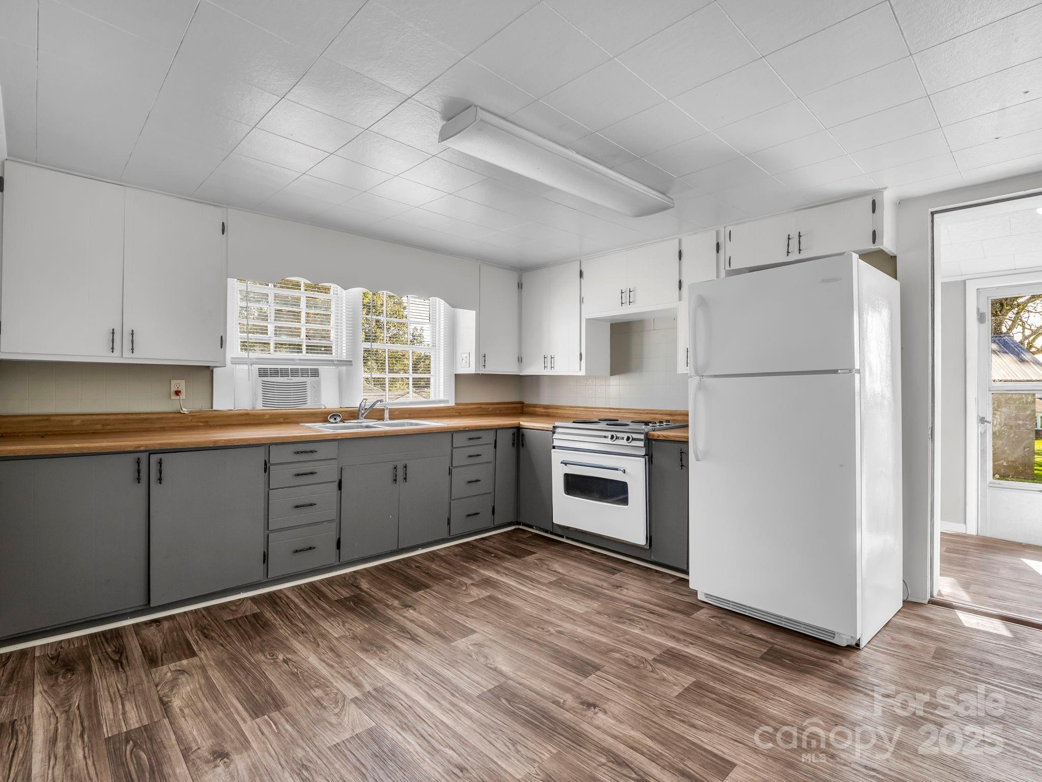264 Goode Road Mooresboro, NC 28114 - Photo 7 of 36 a kitchen with granite countertop white cabinets and white appliances