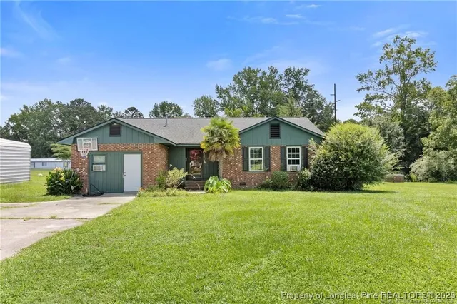 a front view of a house with yard and porch