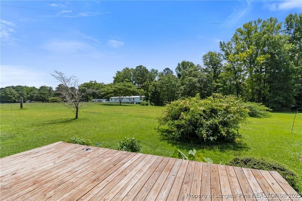 6104 Sisk Culbreth Road Godwin, NC 28344 - Photo 13 of 16 a view of a backyard with plants and a garden