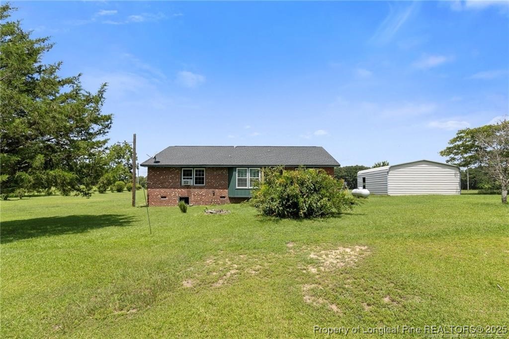 6104 Sisk Culbreth Road Godwin, NC 28344 - Photo 14 of 16 a view of house with garden space and trees