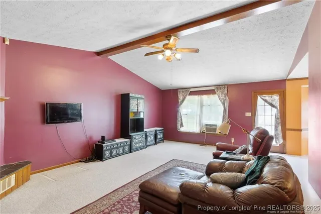 a bedroom with furniture and a flat screen tv