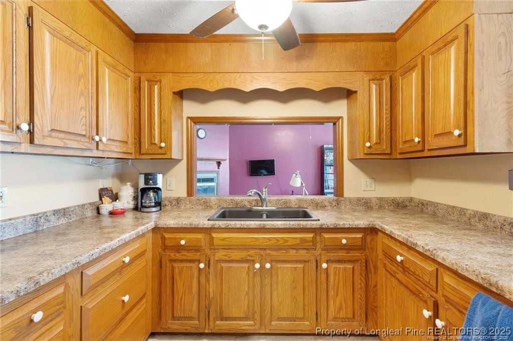 6104 Sisk Culbreth Road Godwin, NC 28344 - Photo 8 of 16 a kitchen with stainless steel appliances granite countertop a sink and cabinets with wooden floor
