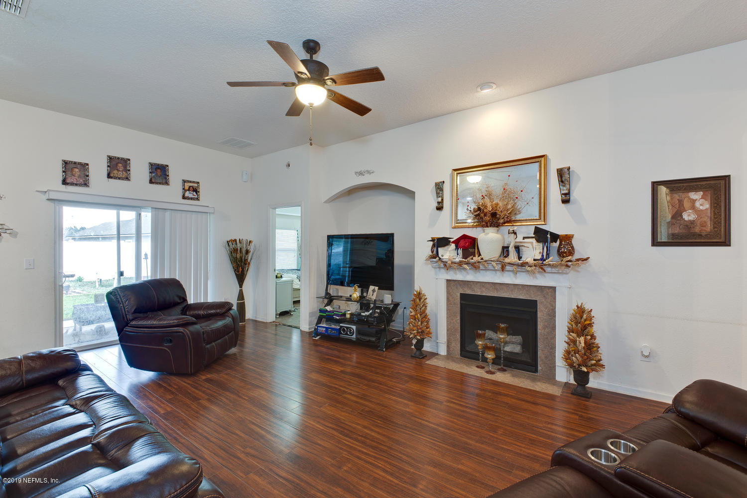 16357 Tisons Bluff Road Jacksonville, FL 32218 - Photo 16 of 31 a living room with furniture and a fireplace