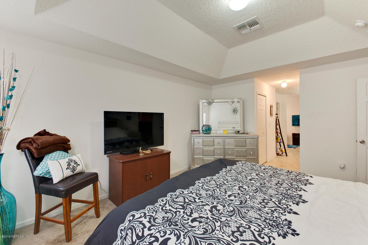 16357 Tisons Bluff Road Jacksonville, FL 32218 - Photo 19 of 31 a living room with furniture and a flat screen tv