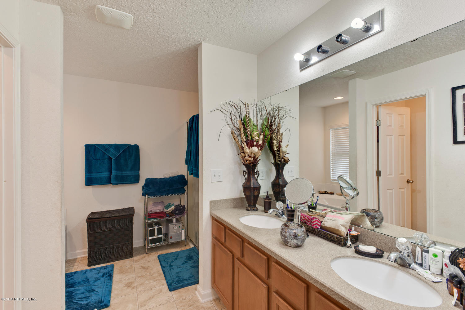 16357 Tisons Bluff Road Jacksonville, FL 32218 - Photo 21 of 31 a bathroom with a double vanity sink and a mirror