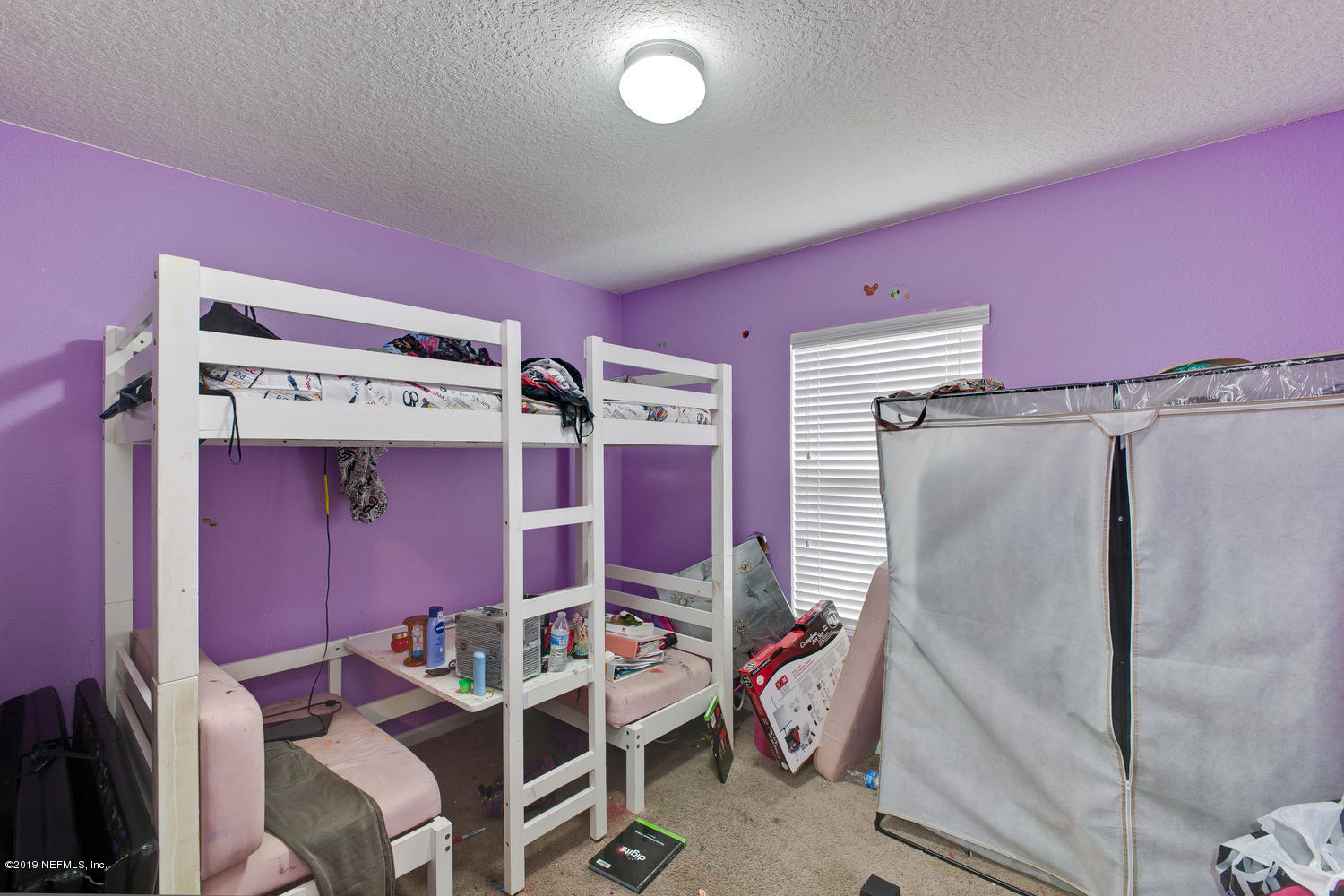 16357 Tisons Bluff Road Jacksonville, FL 32218 - Photo 23 of 31 a bedroom with a bed and a mirror