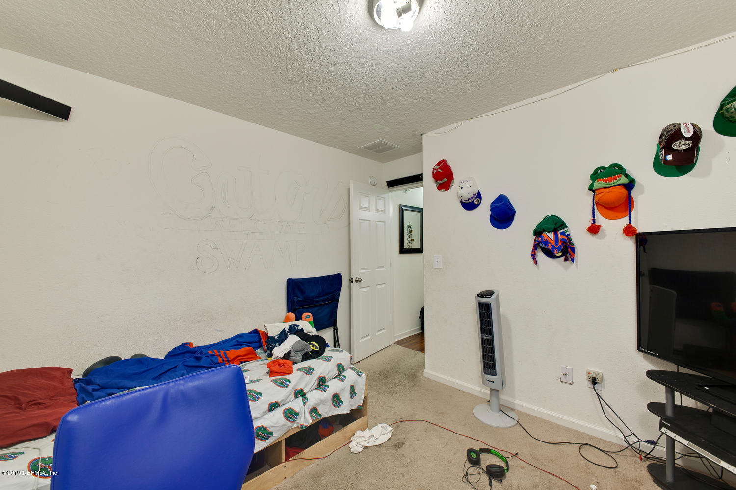 16357 Tisons Bluff Road Jacksonville, FL 32218 - Photo 25 of 31 a living room with furniture and a flat screen tv