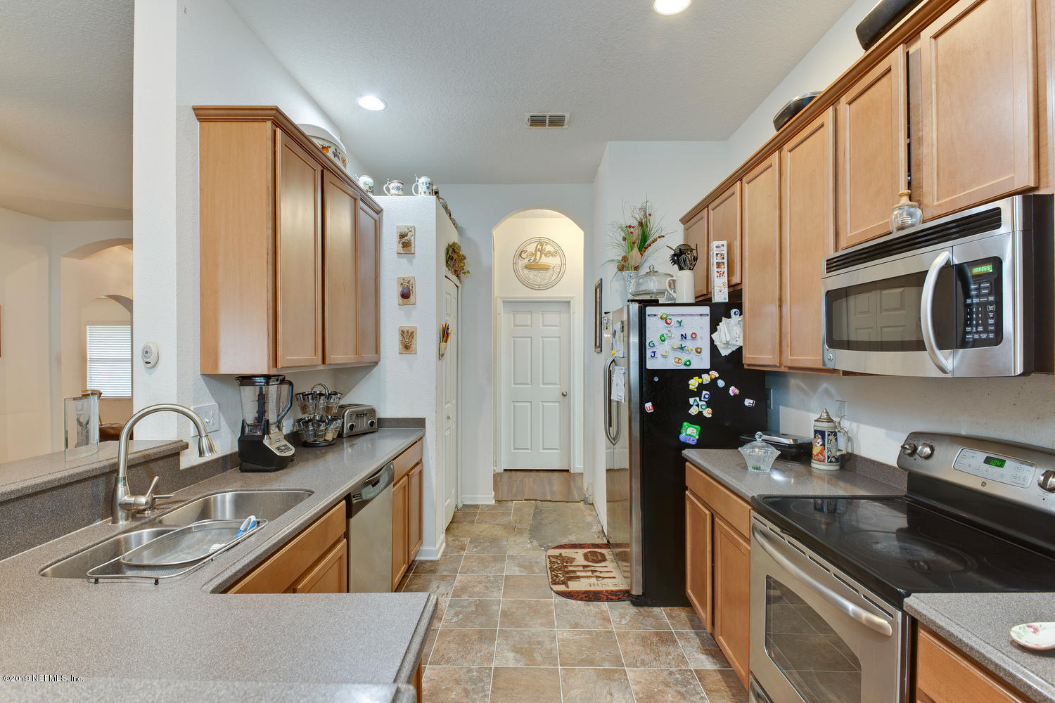 16357 Tisons Bluff Road Jacksonville, FL 32218 - Photo 10 of 31 a kitchen with stainless steel appliances granite countertop a sink stove and refrigerator