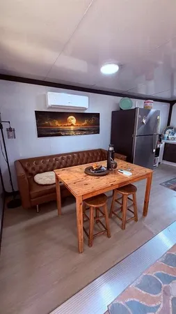 a living room with a table chair and a wooden floor