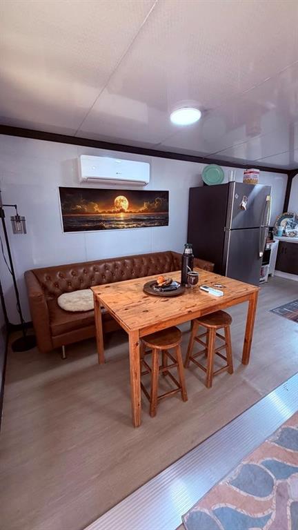 149 South Oak Tree Kemp, TX 75143 - Photo 7 of 14 a living room with a table chair and a wooden floor