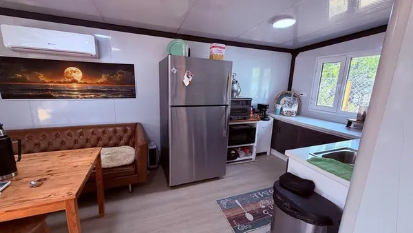 a kitchen with a refrigerator and a stove