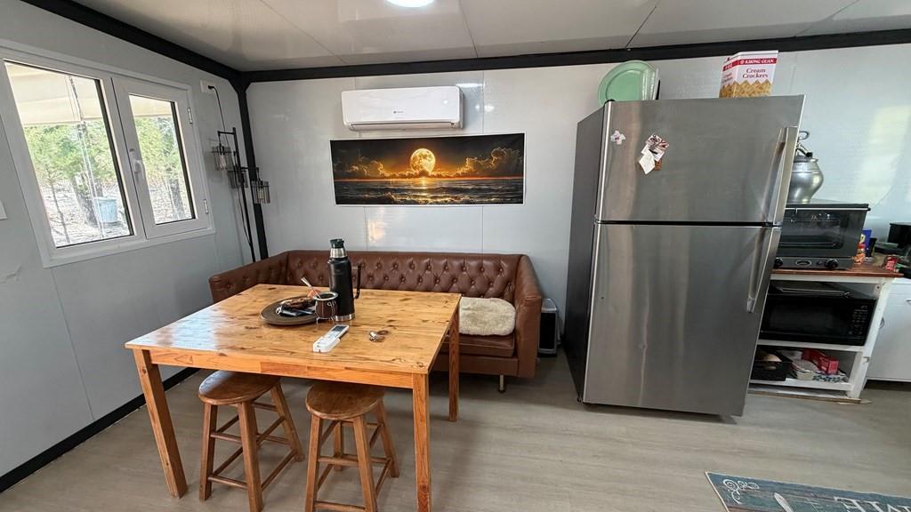 149 South Oak Tree Kemp, TX 75143 - Photo 10 of 14 a kitchen with stainless steel appliances wooden floor and a refrigerator