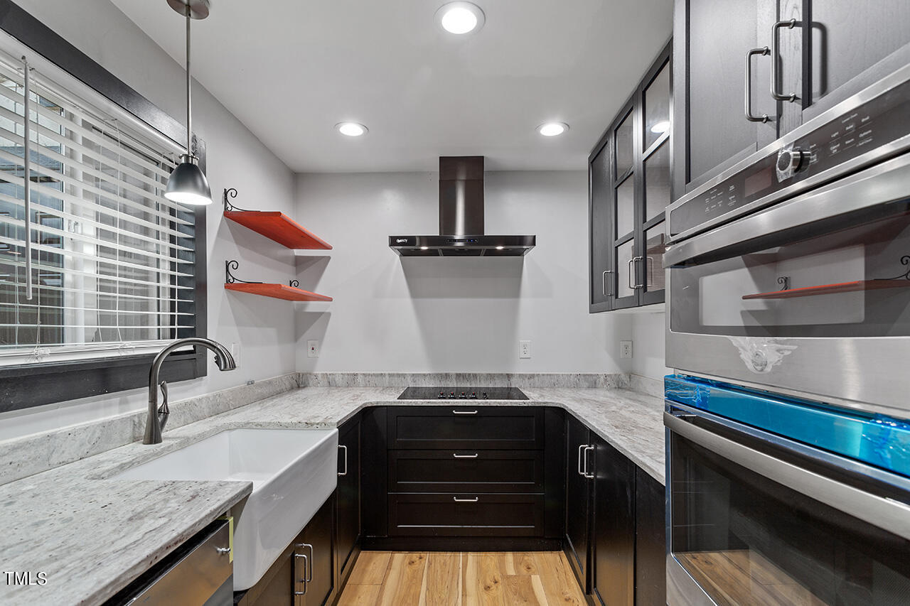 4274 Lake Ridge Drive Raleigh, NC 27604 - Photo 16 of 32 a kitchen with a sink and a stove top oven