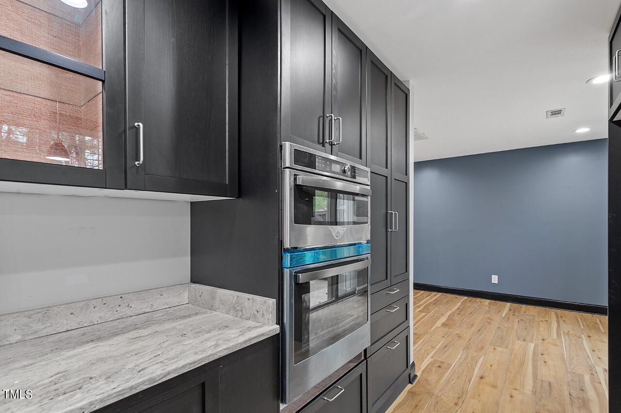 4274 Lake Ridge Drive Raleigh, NC 27604 - Photo 22 of 32 a kitchen with granite countertop cabinets appliances and a counter space