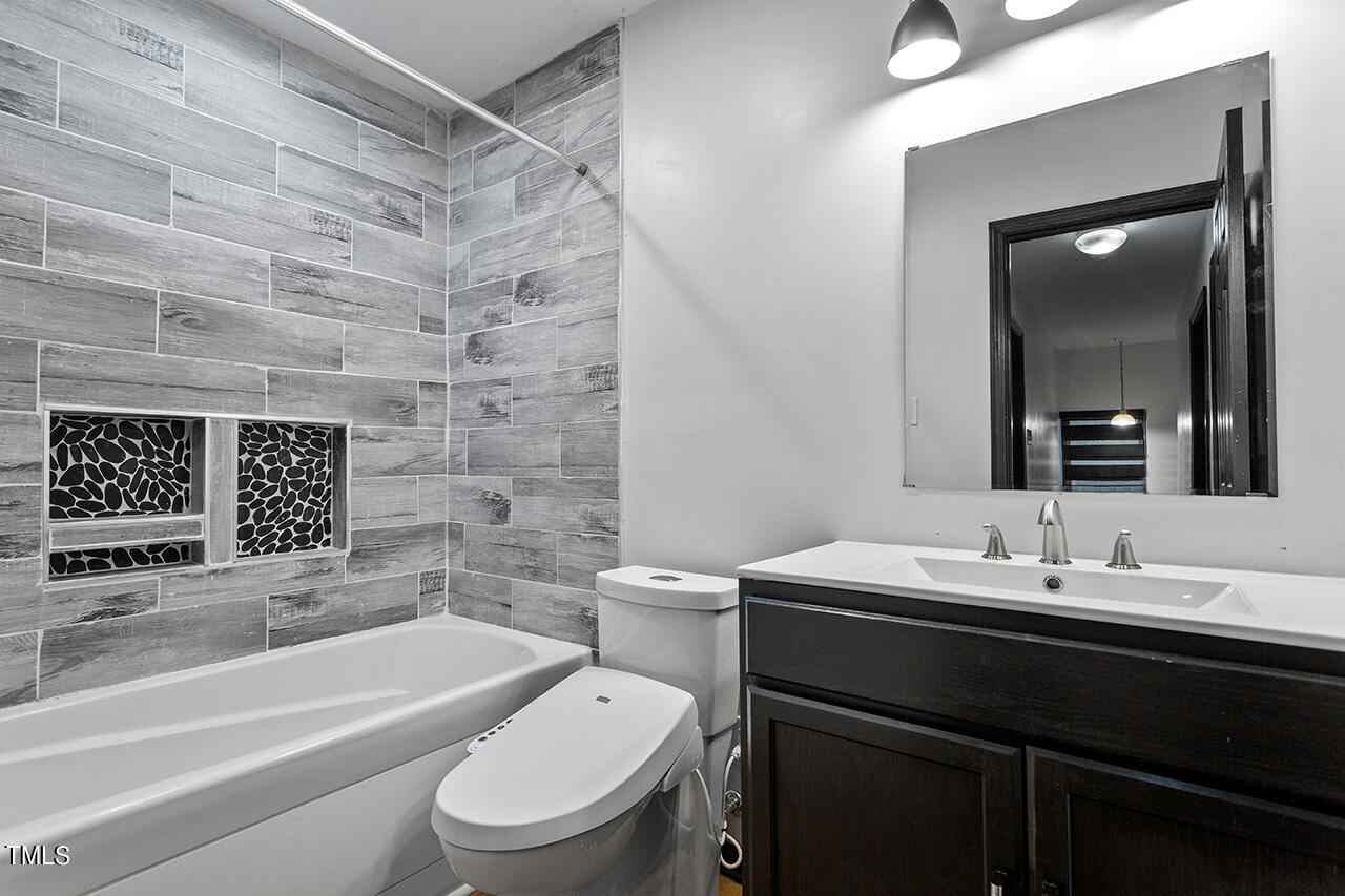 4274 Lake Ridge Drive Raleigh, NC 27604 - Photo 28 of 32 a bathroom with a sink a toilet and shower