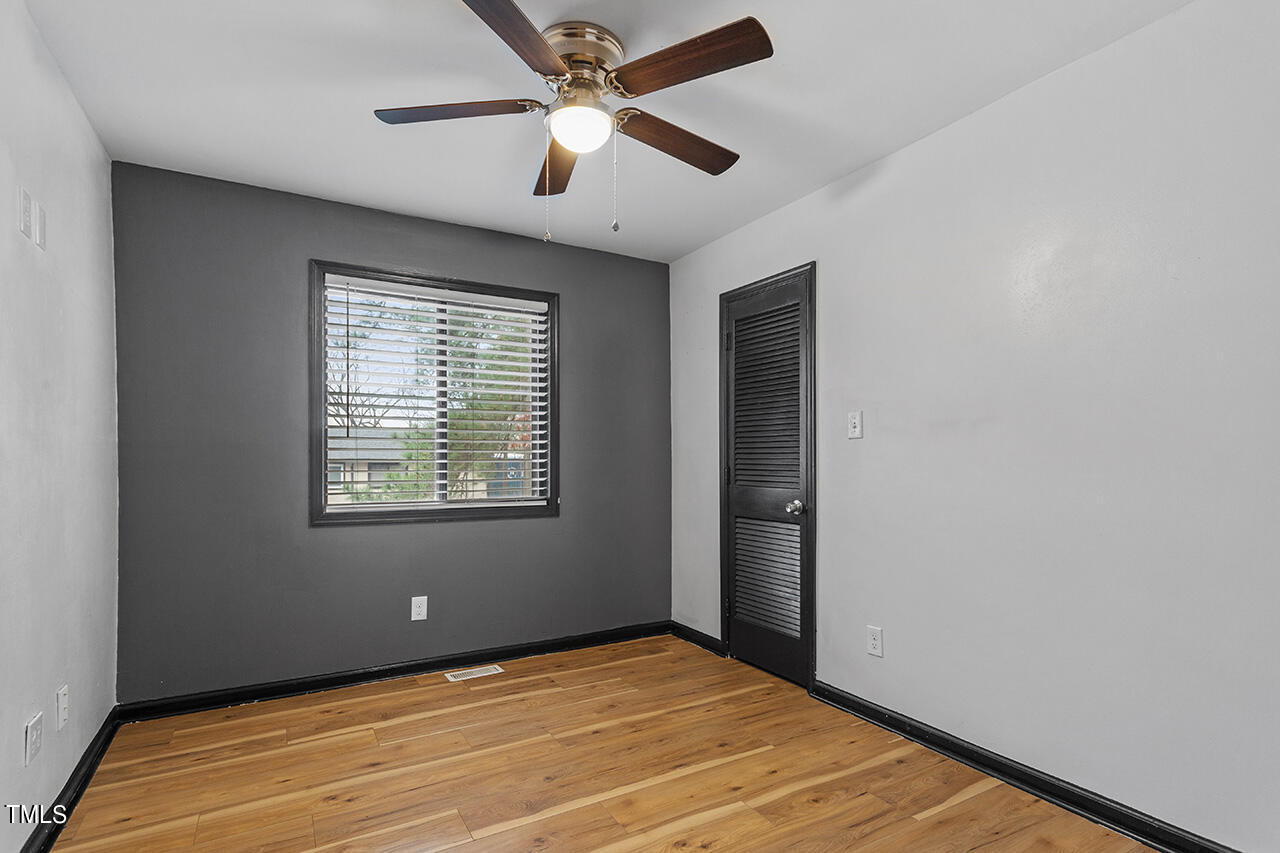 4274 Lake Ridge Drive Raleigh, NC 27604 - Photo 29 of 32 an empty room with a window and a ceiling fan
