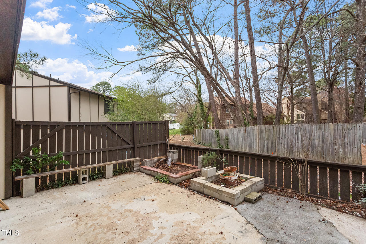 4274 Lake Ridge Drive Raleigh, NC 27604 - Photo 31 of 32 a backyard of a house with table and chairs