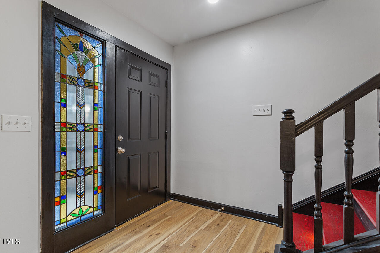 4274 Lake Ridge Drive Raleigh, NC 27604 - Photo 5 of 32 a view of an entryway with wooden floor and stairs