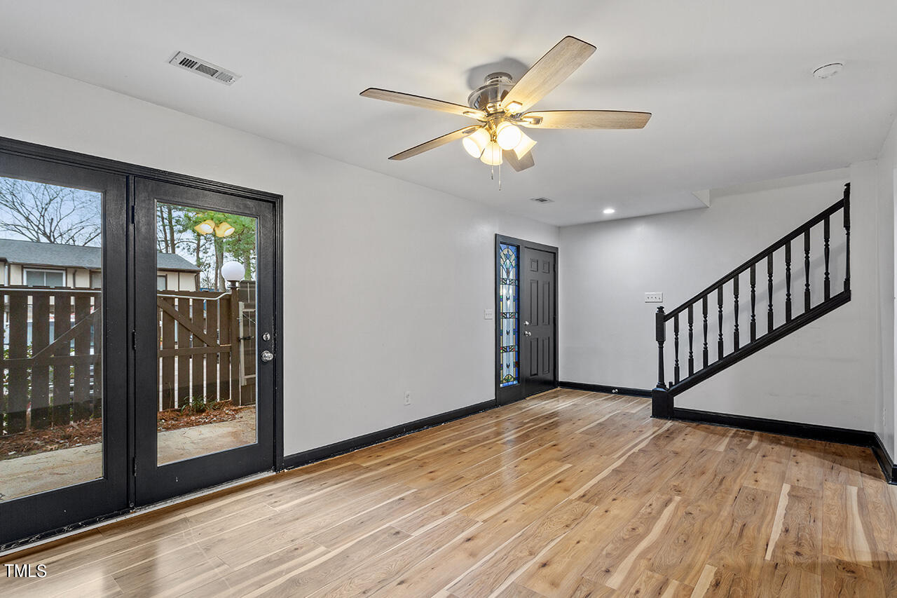 4274 Lake Ridge Drive Raleigh, NC 27604 - Photo 7 of 32 a view of an empty room with wooden floor and a window