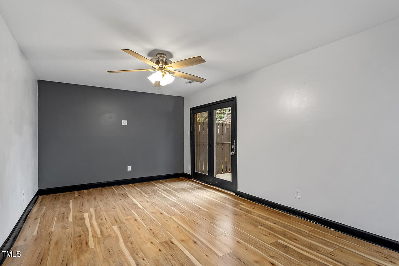 4274 Lake Ridge Drive Raleigh, NC 27604 - Photo 9 of 32 a view of an empty room with window and wooden floor