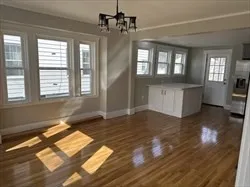 a kitchen with stainless steel appliances granite countertop a refrigerator a sink a stove a microwave and wooden floor