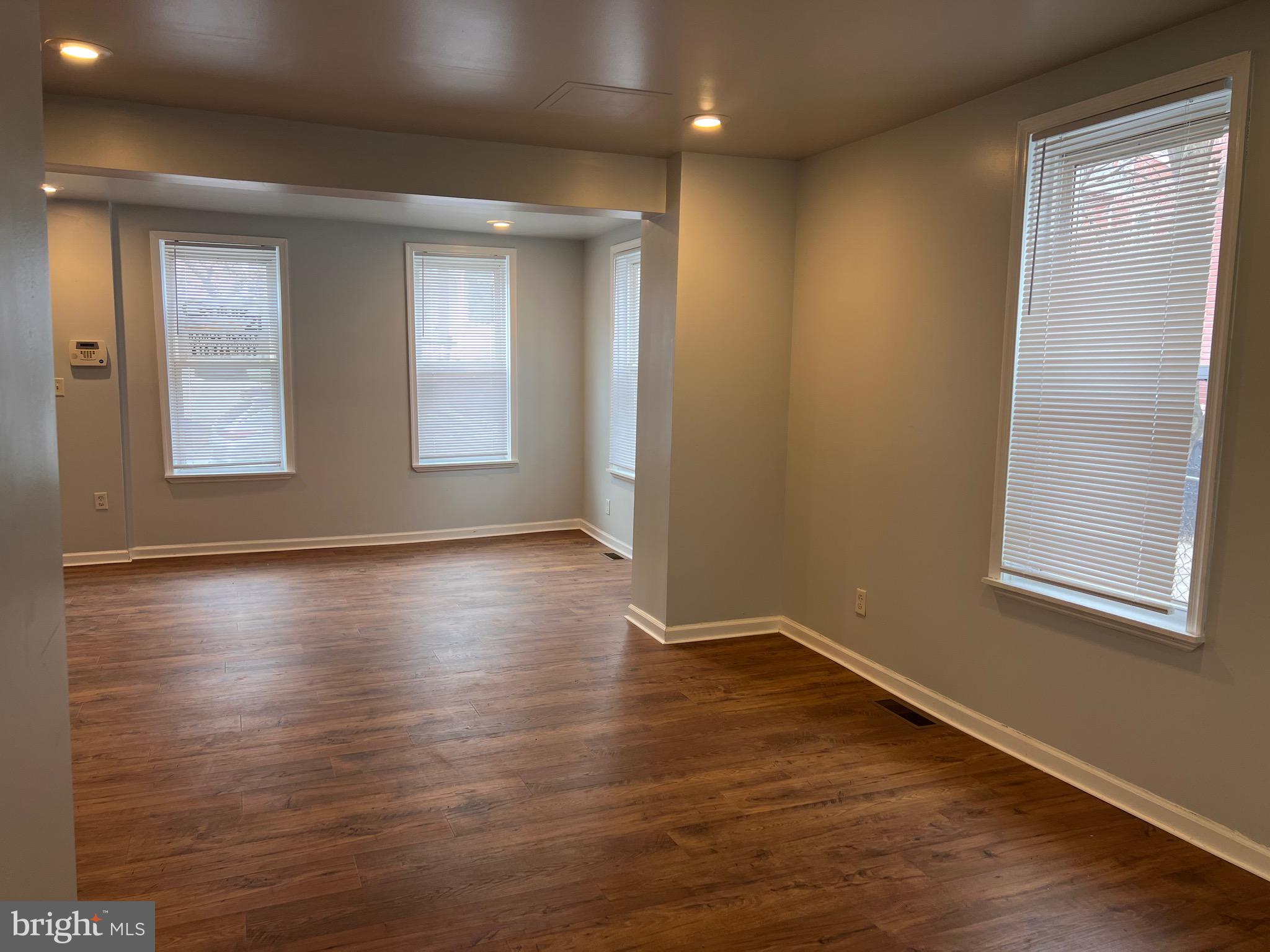 427 Pawnee Street Bethlehem, PA 18015 - Photo 14 of 39 an empty room with wooden floor and windows