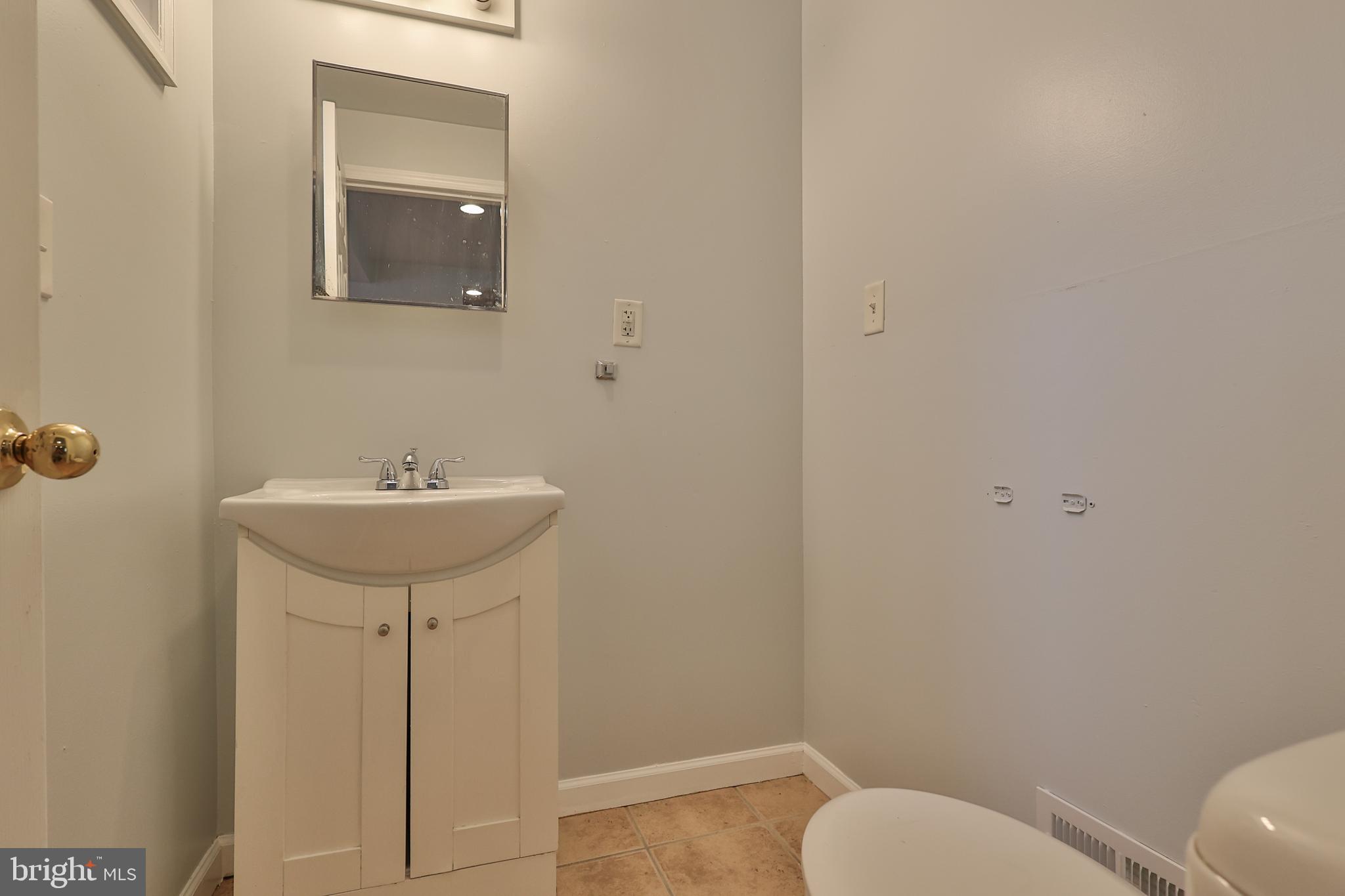 427 Pawnee Street Bethlehem, PA 18015 - Photo 15 of 39 a bathroom with a sink toilet and a mirror
