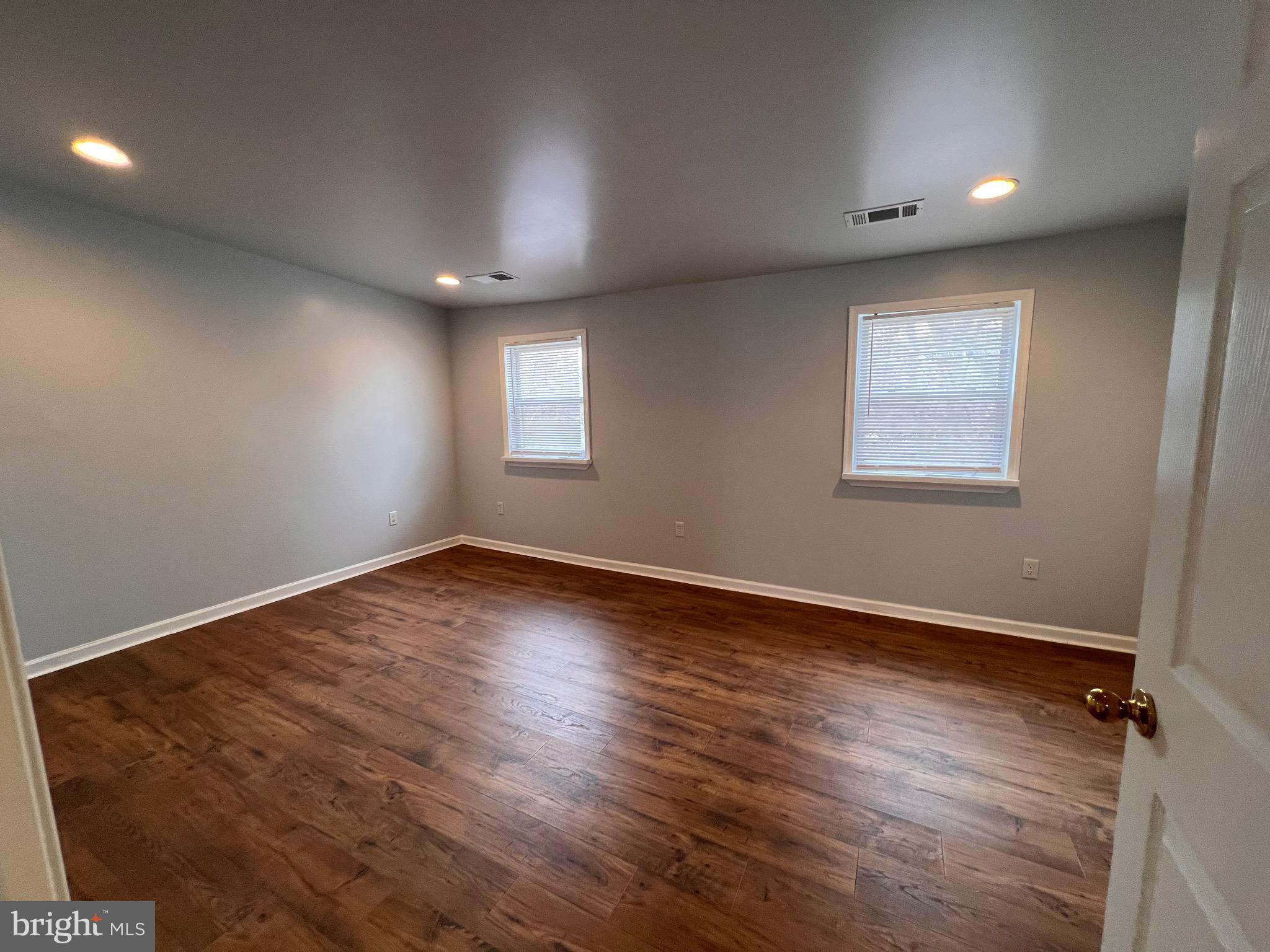 427 Pawnee Street Bethlehem, PA 18015 - Photo 19 of 39 an empty room with wooden floor and windows