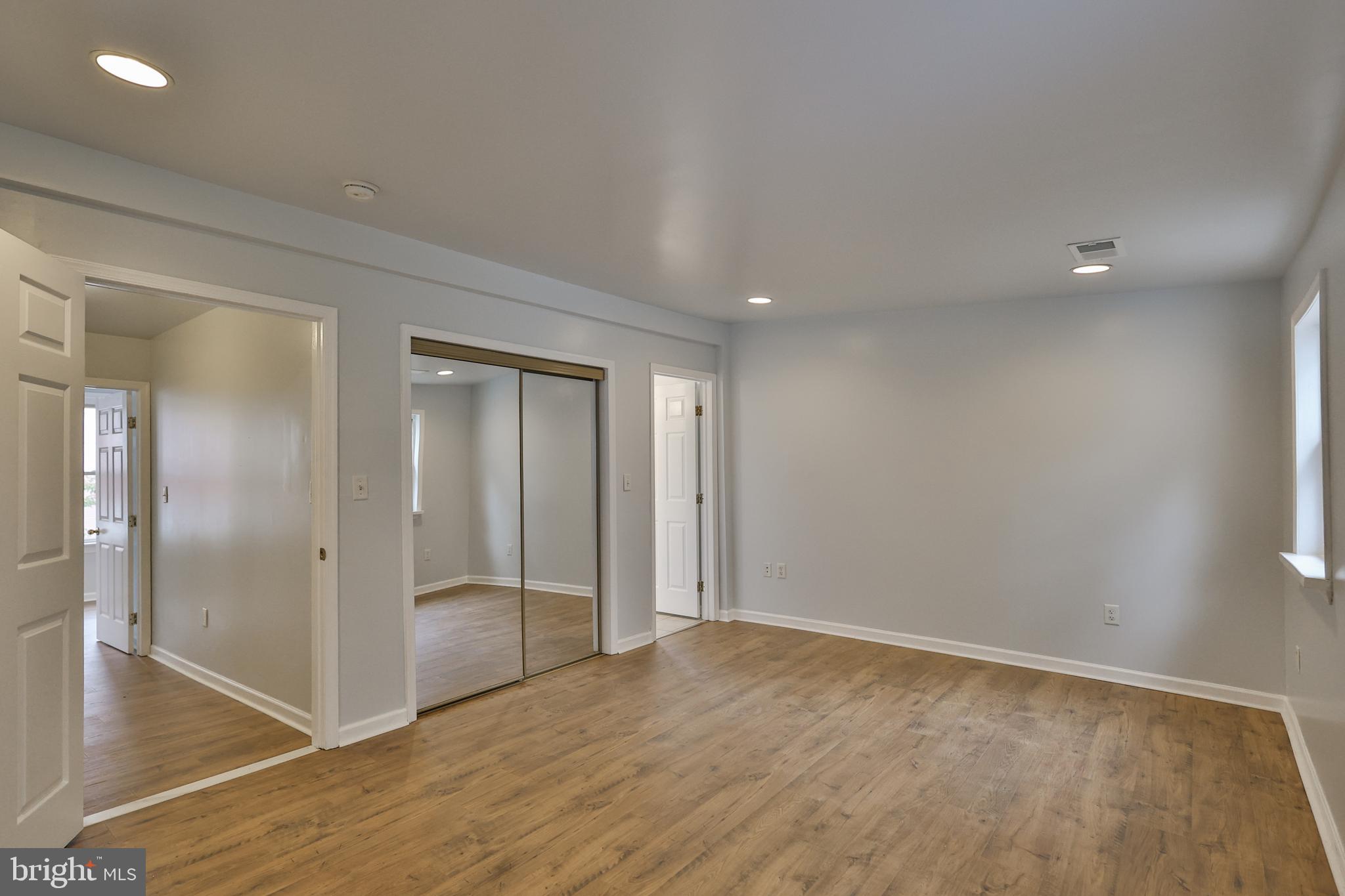427 Pawnee Street Bethlehem, PA 18015 - Photo 20 of 39 an empty room with wooden floor and mirror