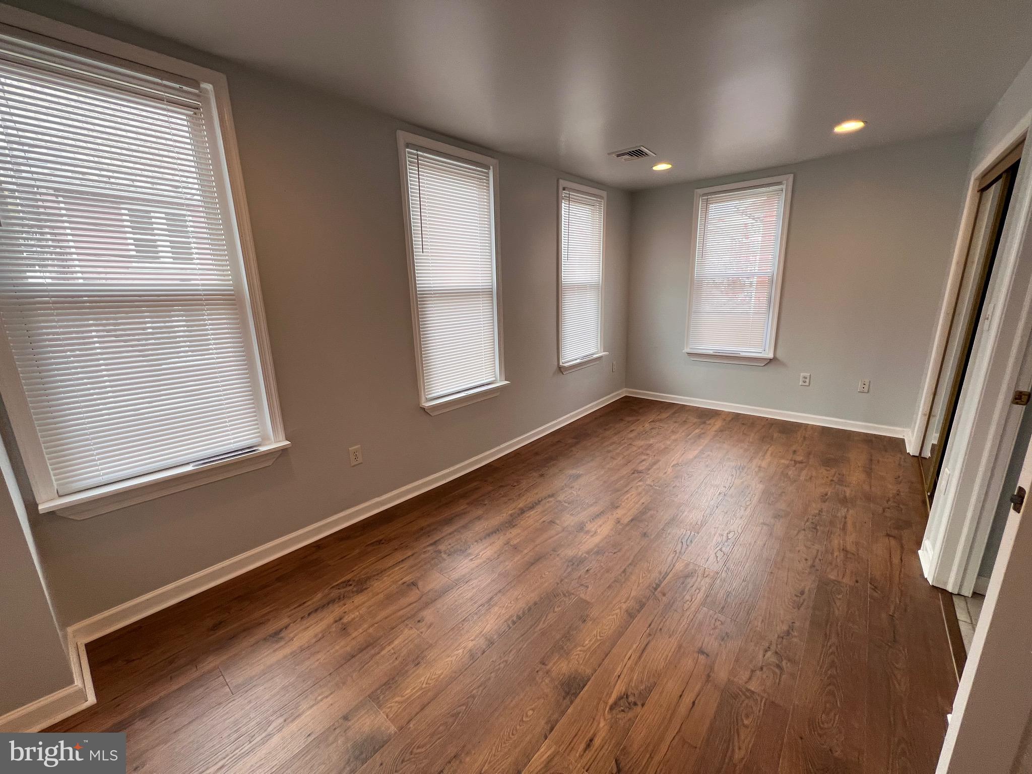 427 Pawnee Street Bethlehem, PA 18015 - Photo 24 of 39 an empty room with wooden floor and windows