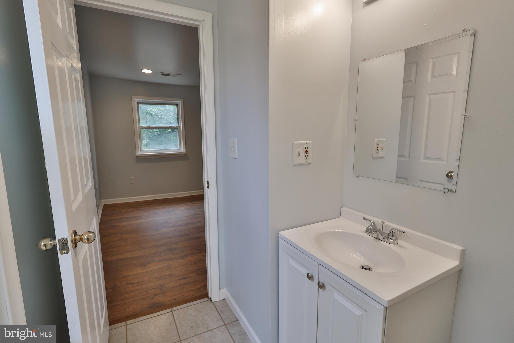 427 Pawnee Street Bethlehem, PA 18015 - Photo 27 of 39 a bathroom with a sink and mirror with toilet