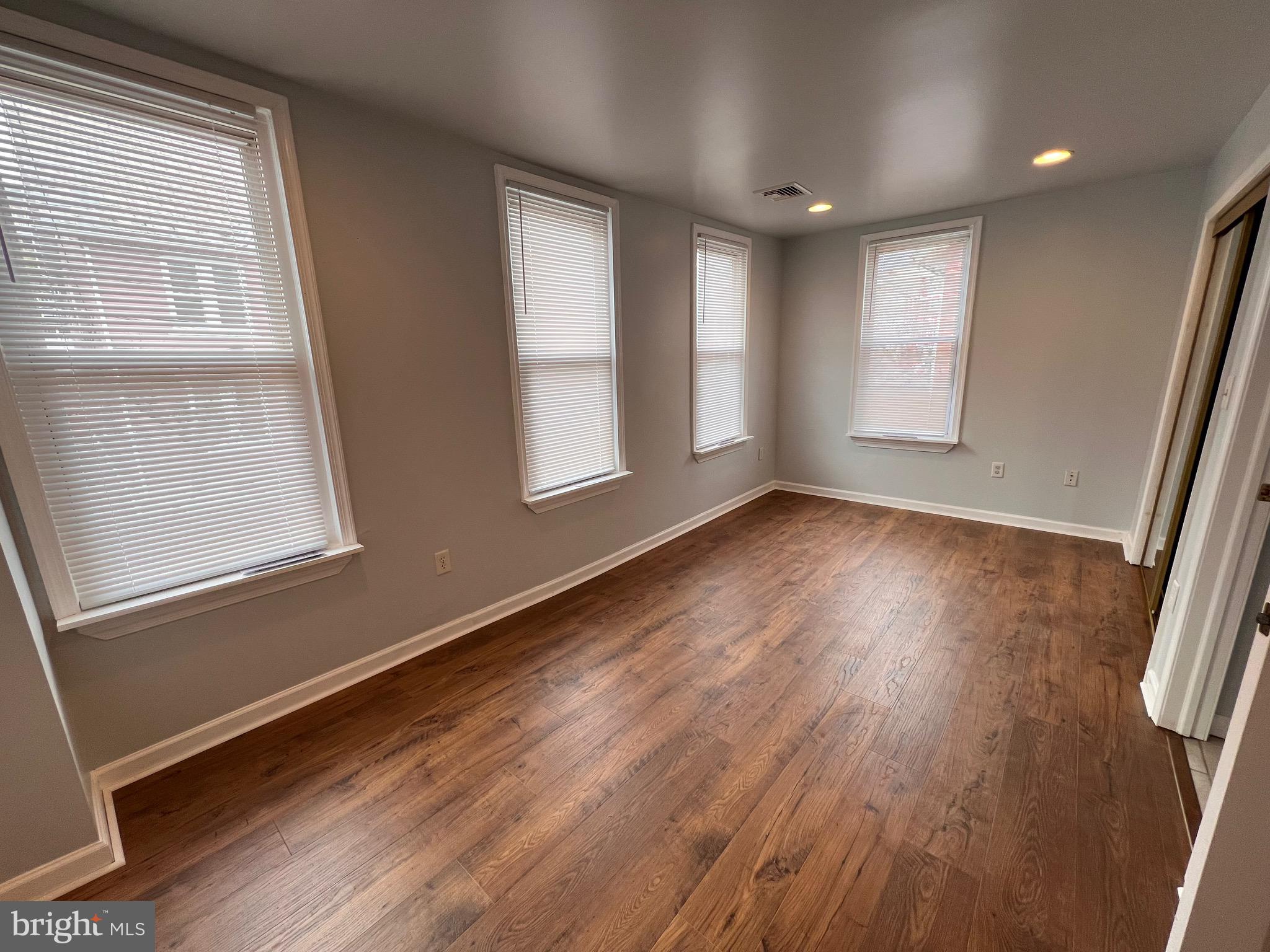 427 Pawnee Street Bethlehem, PA 18015 - Photo 29 of 39 an empty room with wooden floor and windows
