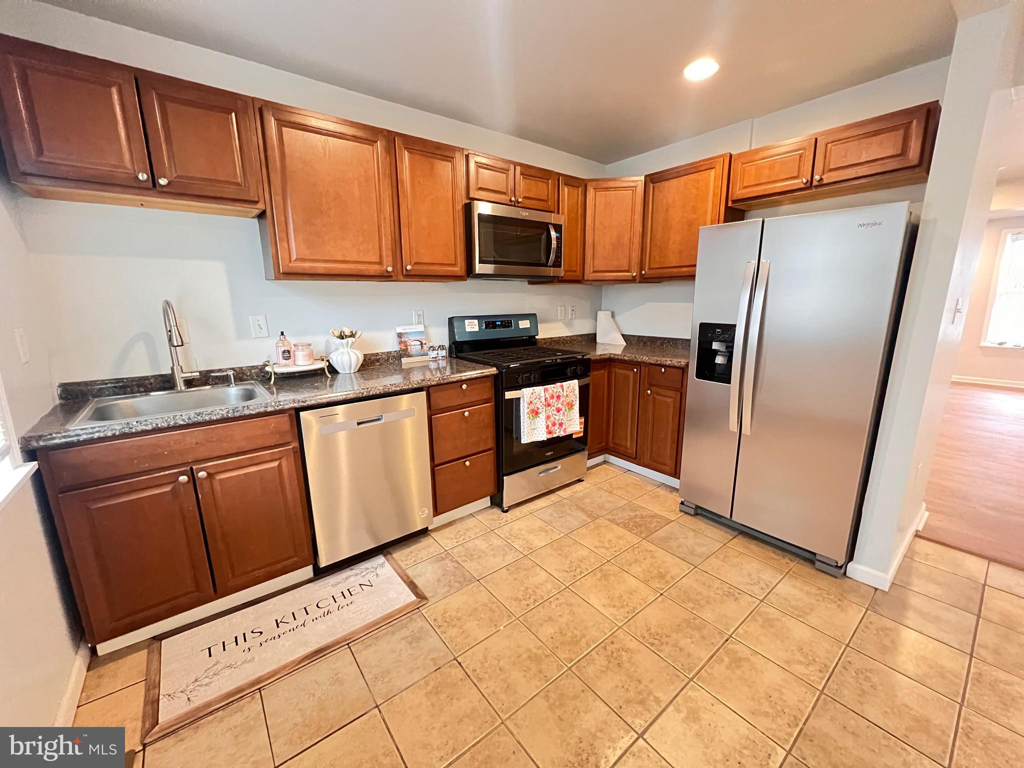 427 Pawnee Street Bethlehem, PA 18015 - Photo 5 of 39 a kitchen with stainless steel appliances a refrigerator sink and microwave
