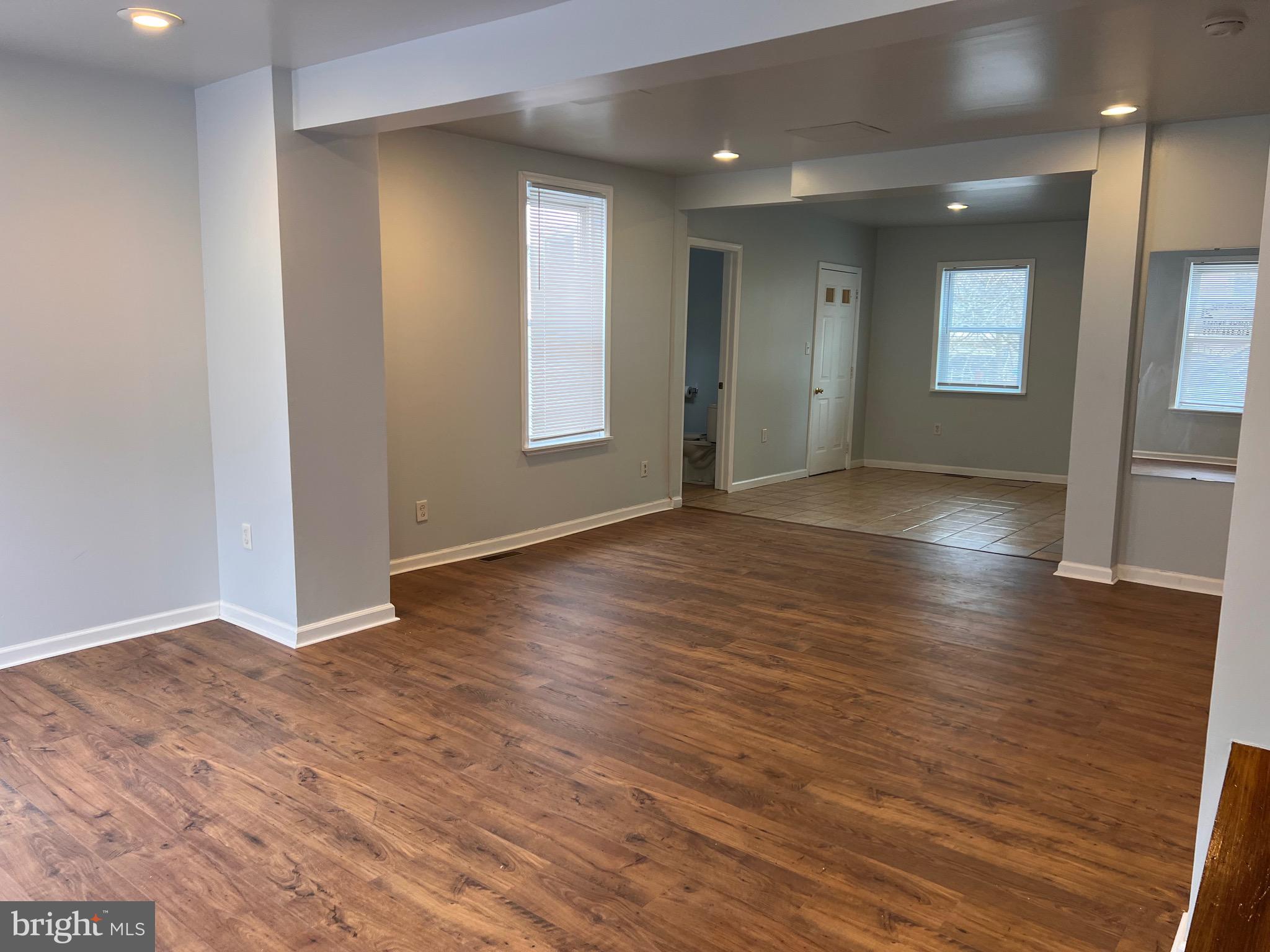 427 Pawnee Street Bethlehem, PA 18015 - Photo 7 of 39 an empty room with wooden floor and windows