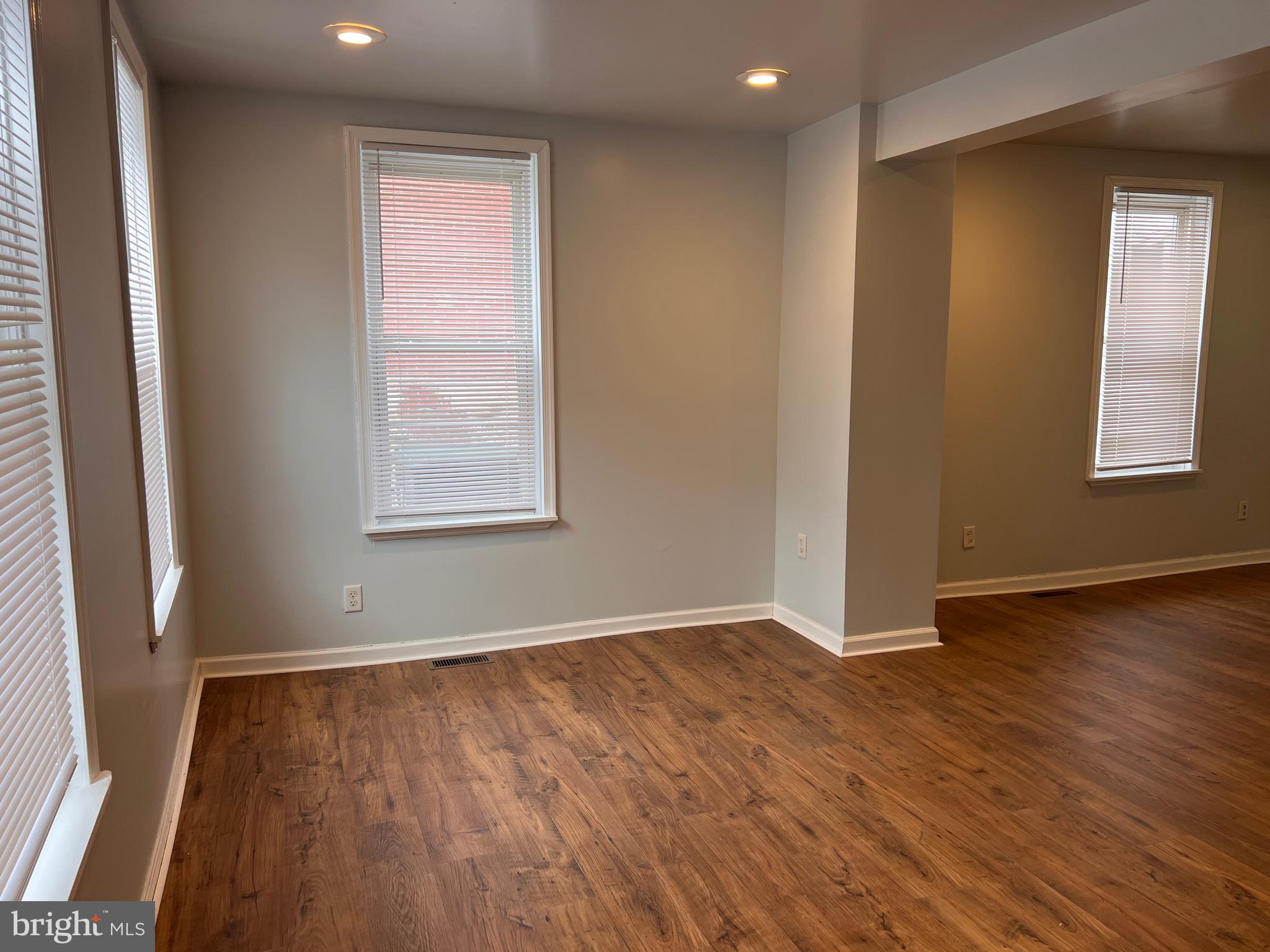427 Pawnee Street Bethlehem, PA 18015 - Photo 8 of 39 an empty room with wooden floor and windows