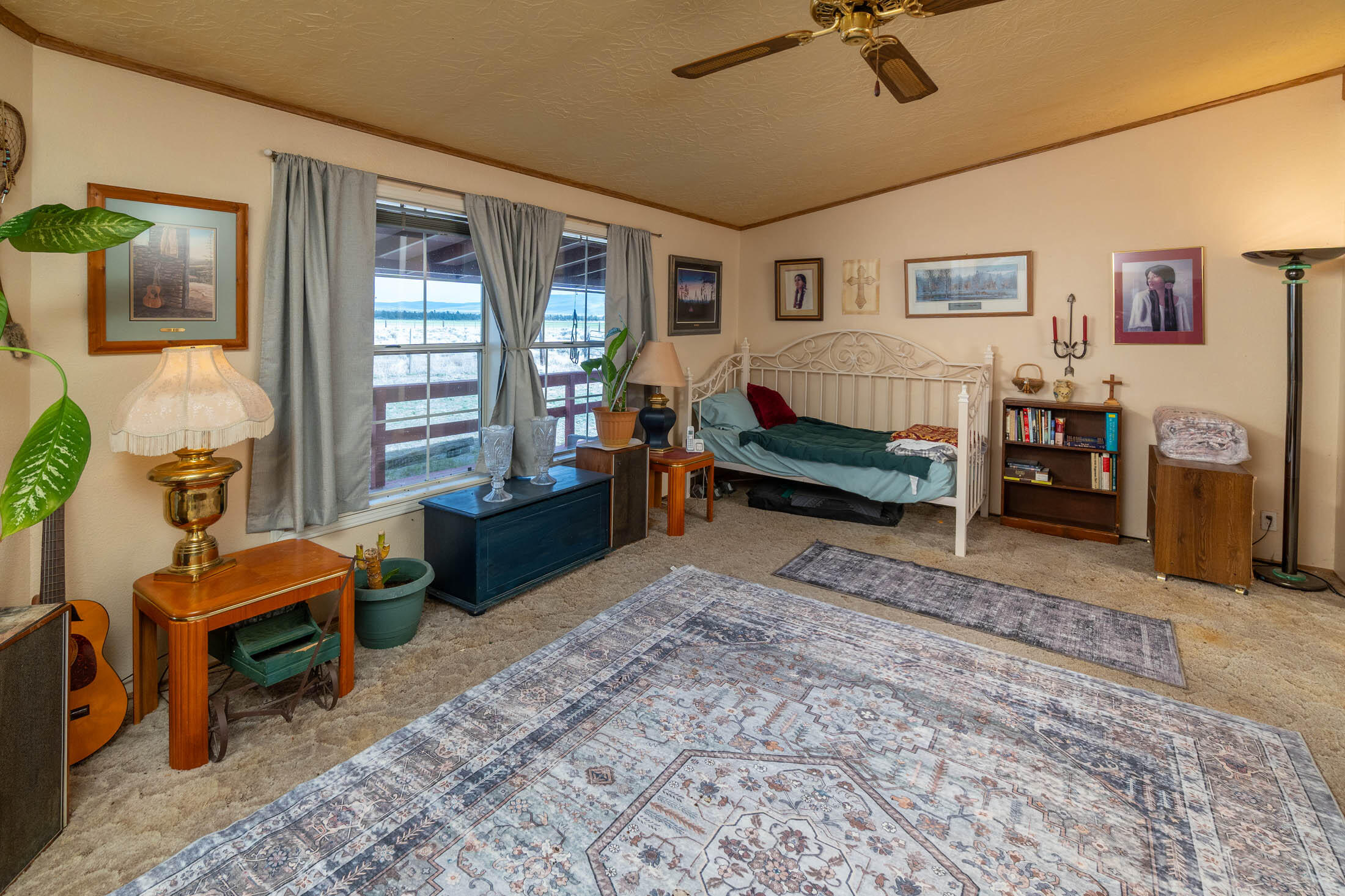 25907 South Cooper Street Bend, OR 97701 - Photo 13 of 34 a bed room with furniture and a window