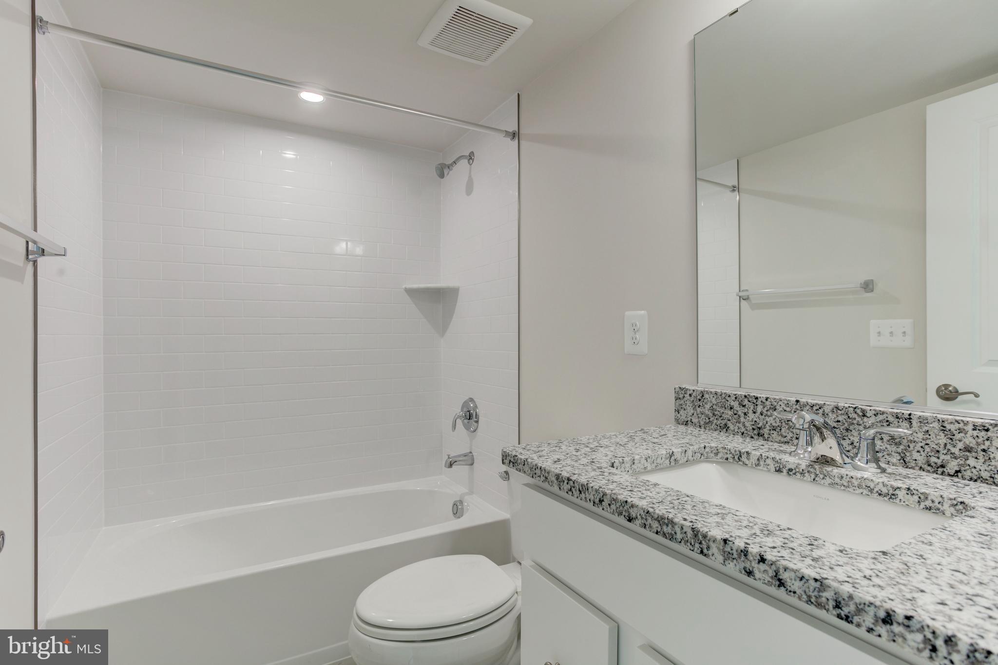 13172 Arches Road Herndon, VA 20170 - Photo 17 of 31 a bathroom with a granite countertop bathtub shower sink vanity and toilet