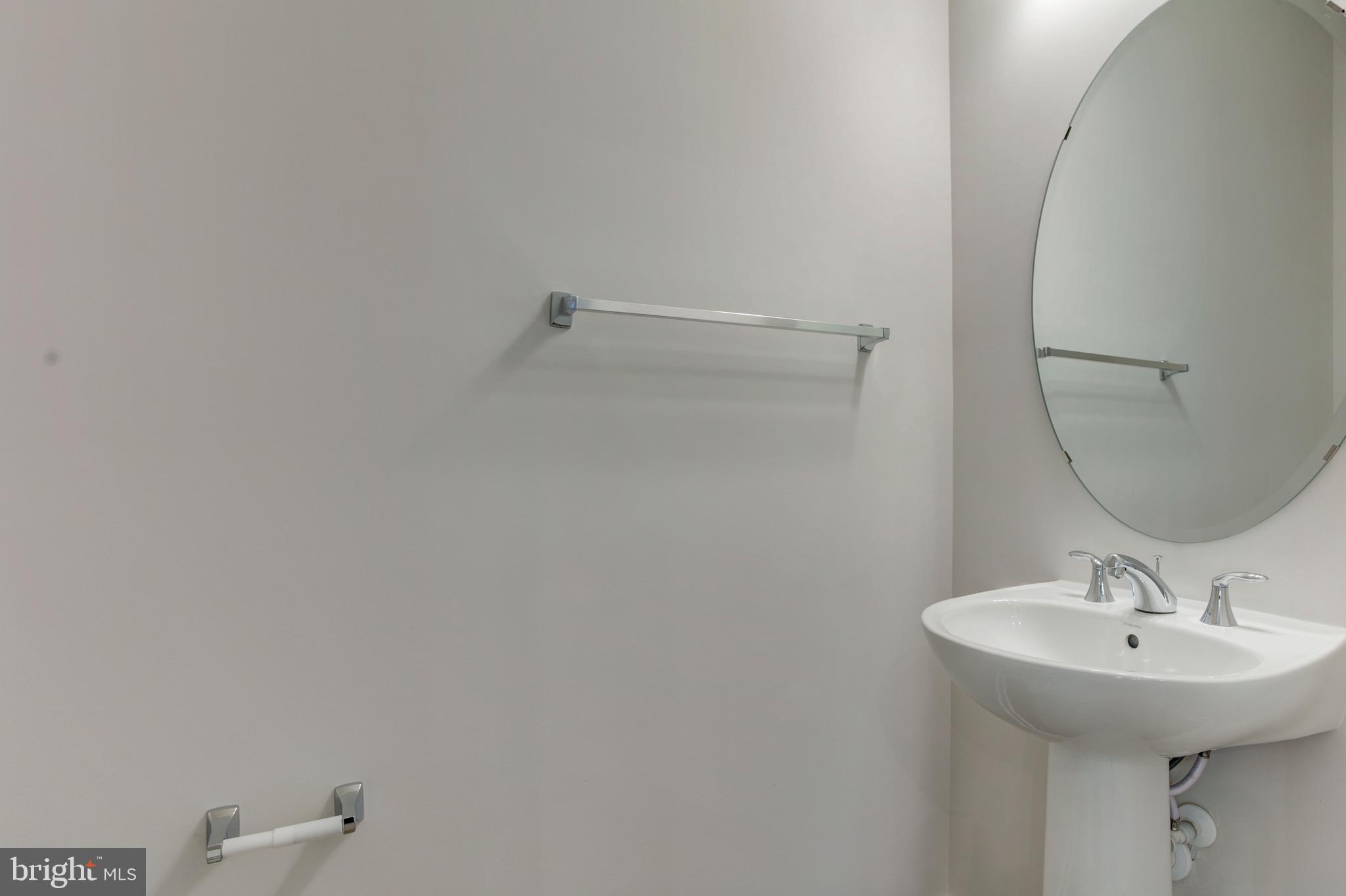 13172 Arches Road Herndon, VA 20170 - Photo 18 of 31 a bathroom with a sink and mirror