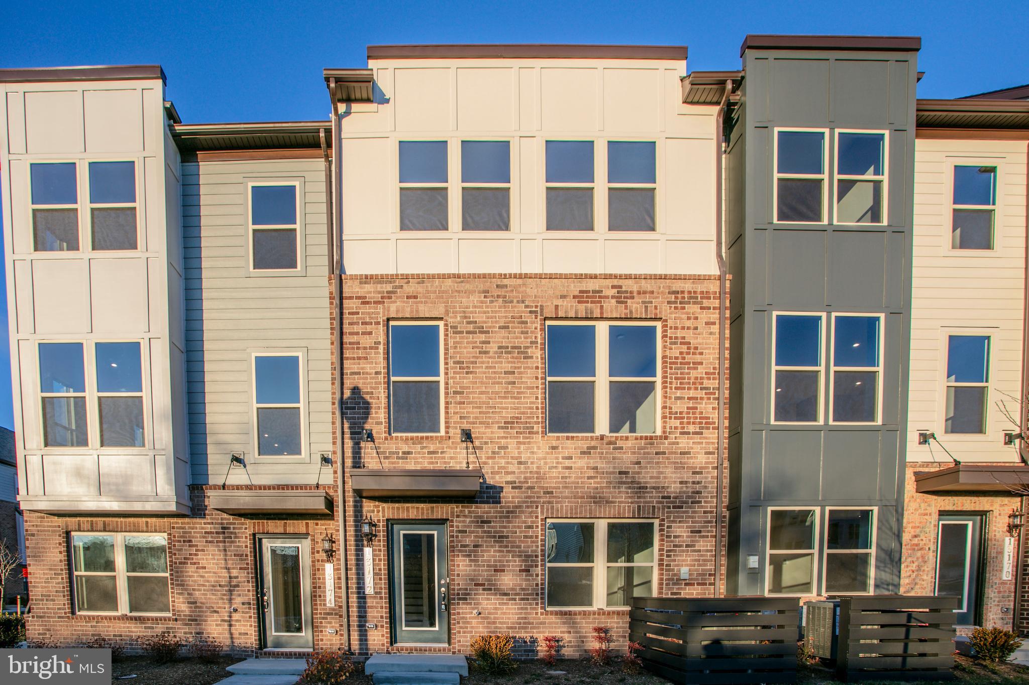 13172 Arches Road Herndon, VA 20170 - Photo 2 of 31 a front view of a building with many windows