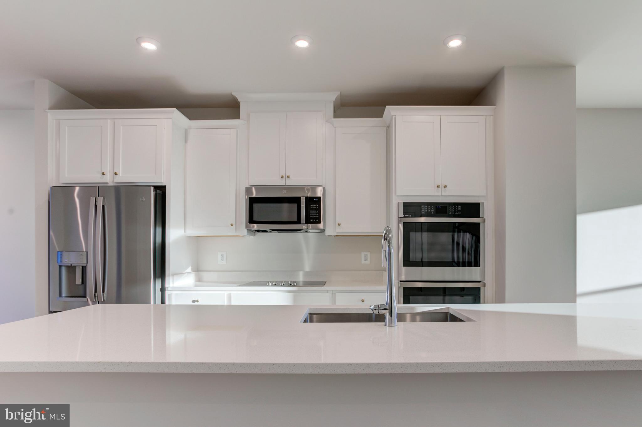 13172 Arches Road Herndon, VA 20170 - Photo 3 of 31 a kitchen with stainless steel appliances kitchen island granite countertop a refrigerator and a stove top oven