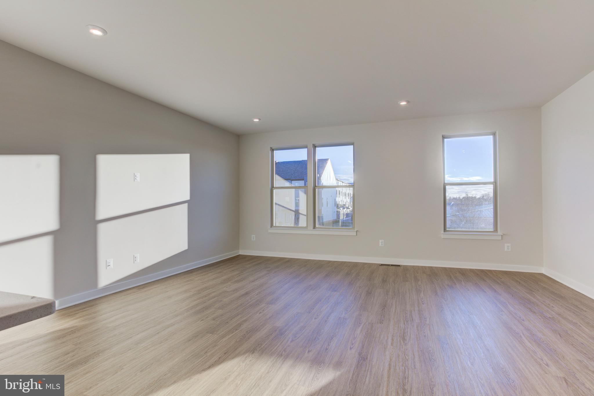 13172 Arches Road Herndon, VA 20170 - Photo 8 of 31 an empty room with wooden floor and windows